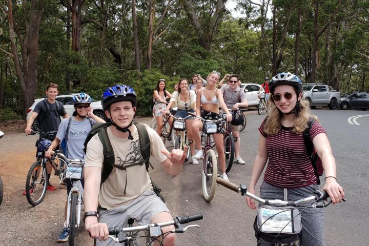 a group of people riding on the back of a bicycle