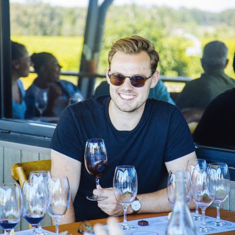 a group of people sitting at a table with wine glasses