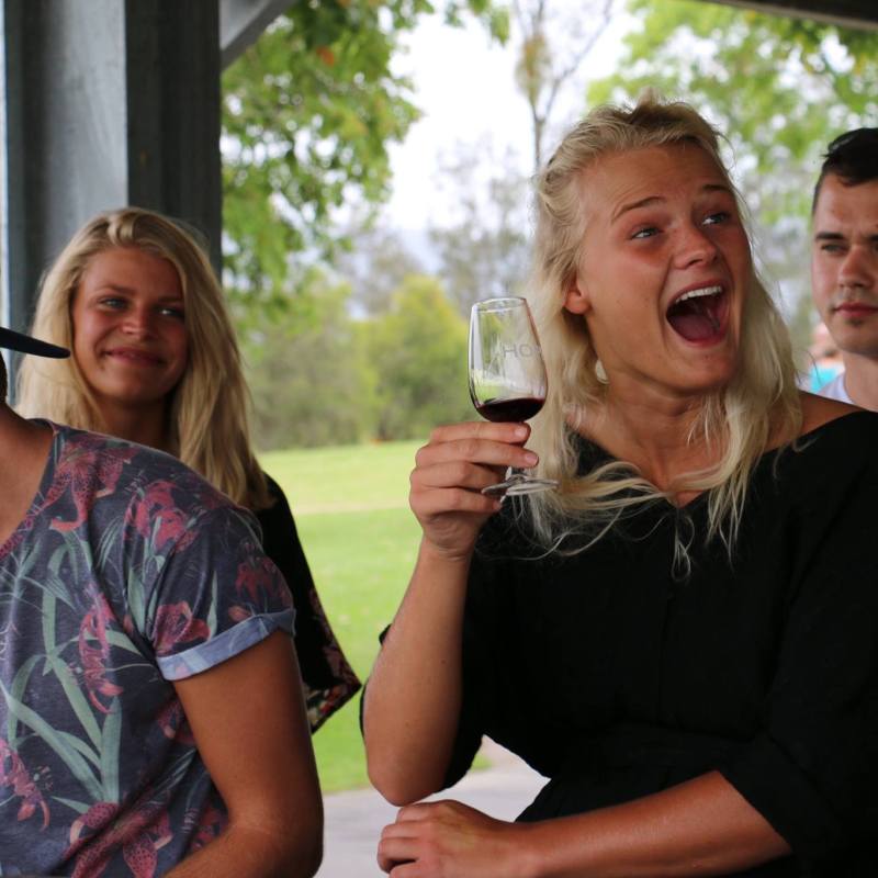 a group of people holding wine glasses