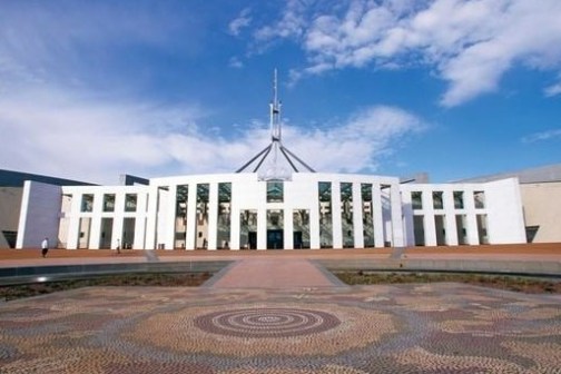 a large building with Parliament House, Canberra in the background