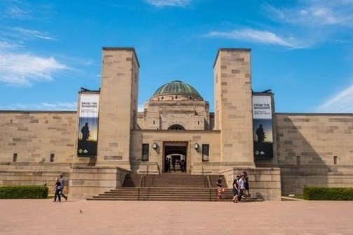 a large building with Baths of Caracalla in the background