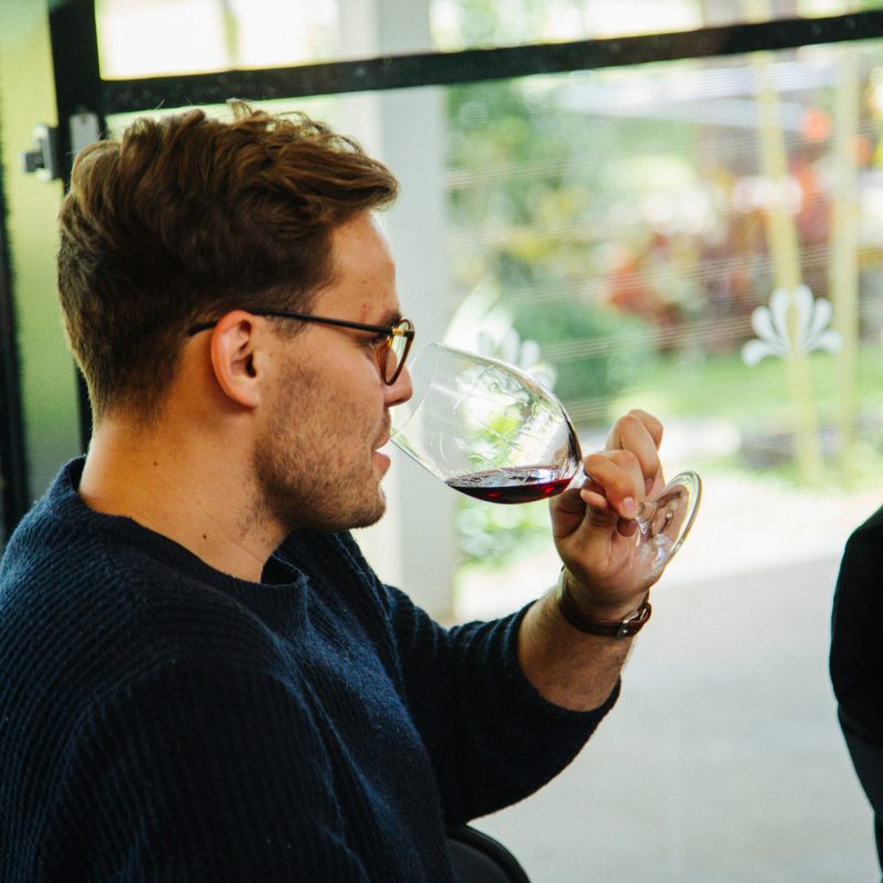 a man and a woman standing in front of a window