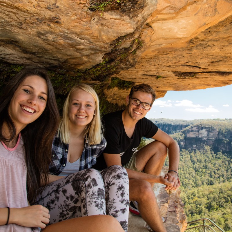a couple of people that are sitting on a rock