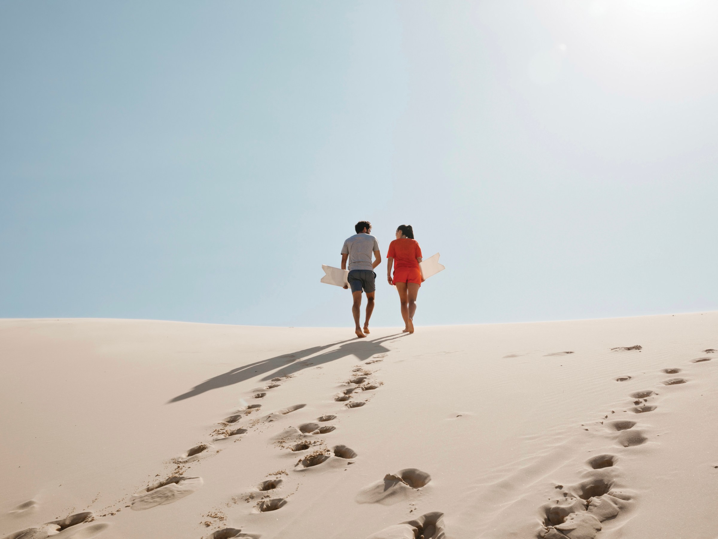 a group of people walking across a snow covered slope