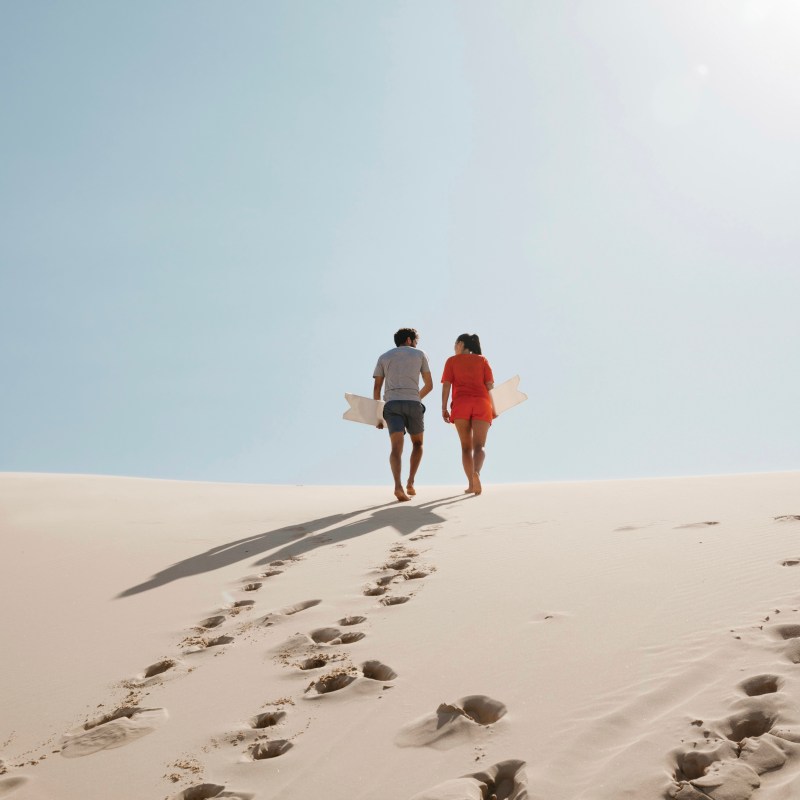 a group of people walking across a snow covered slope
