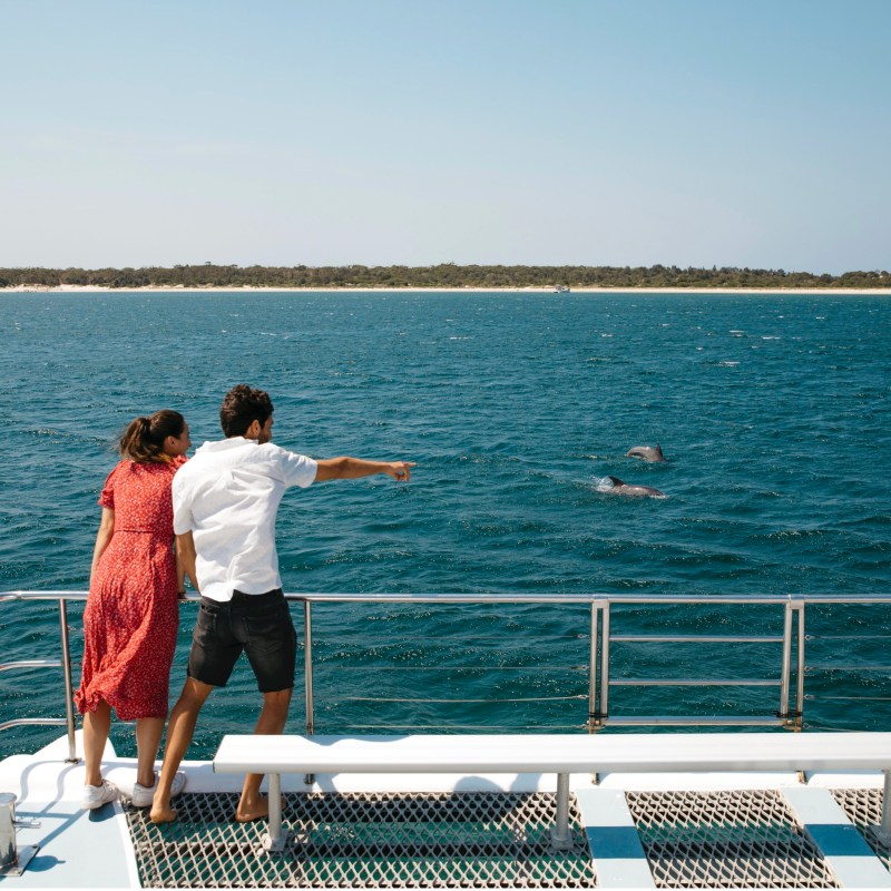 a man standing next to a body of water