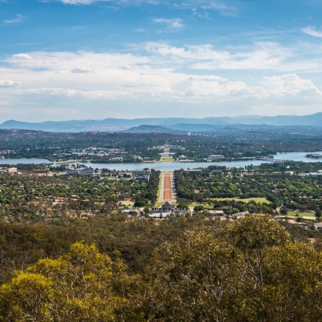 a large body of water with a city in the background